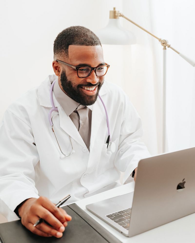 9 matching baby bottle nipples viewed from above on a purple background.
