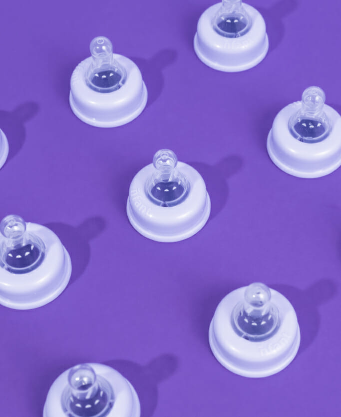 An assortment of nfant® Slow Flow Nipples for baby bottles is shown.