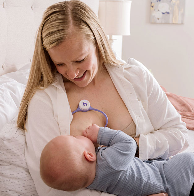 Woman feeling confident in breast feeding her baby with Nfant